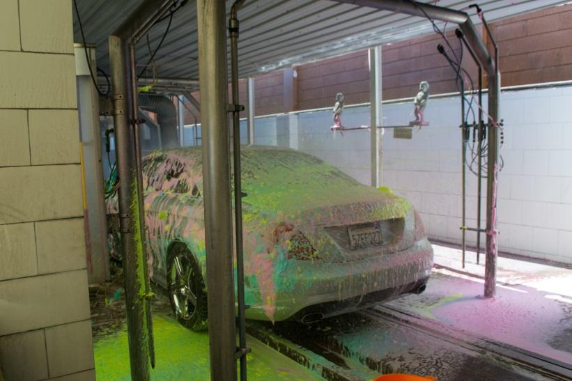 Car in multicolored car wash